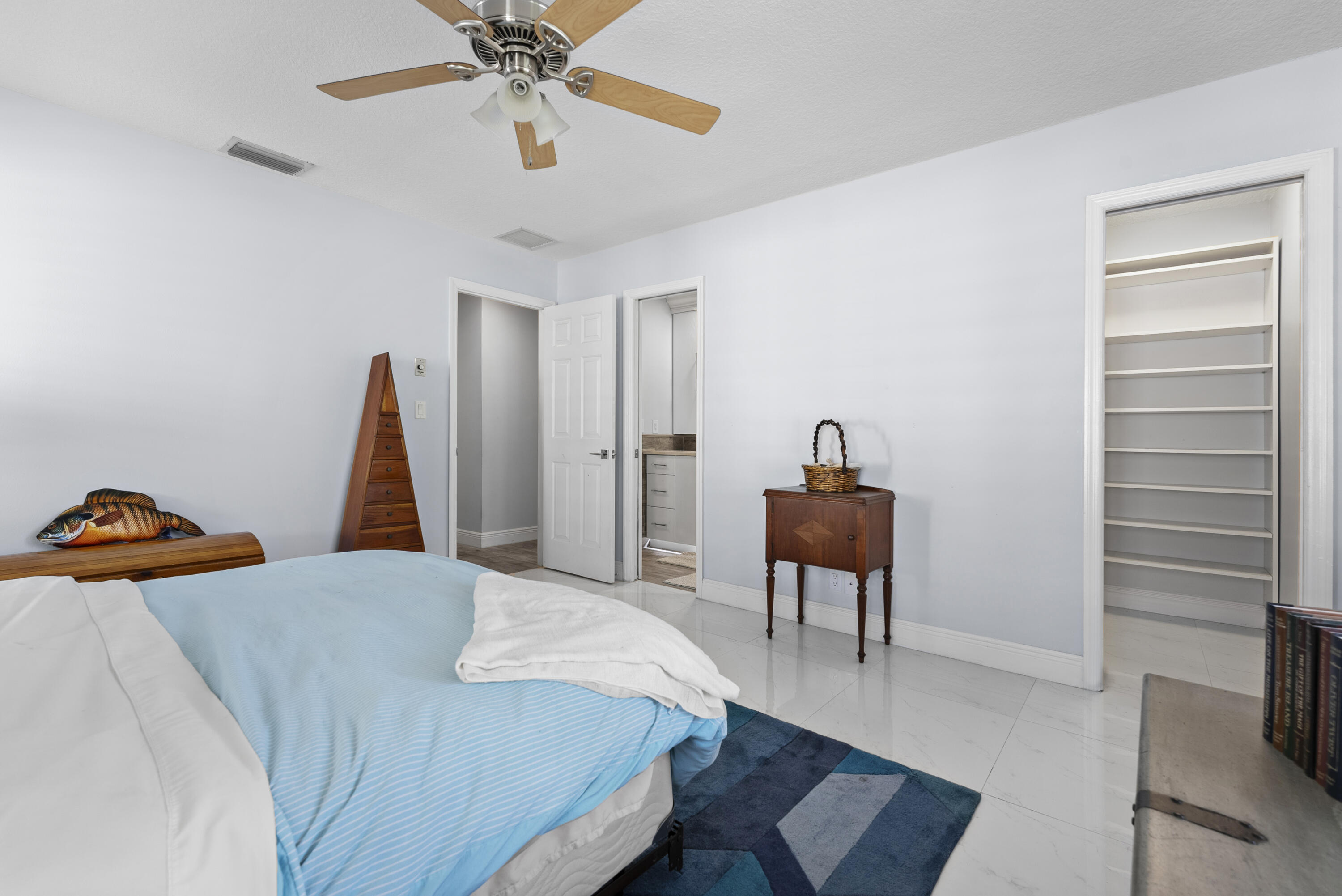 334 Northwest 42nd Street Boca Raton, FL 33431 - Photo 35 of 48 a bedroom with a bed and a chandelier