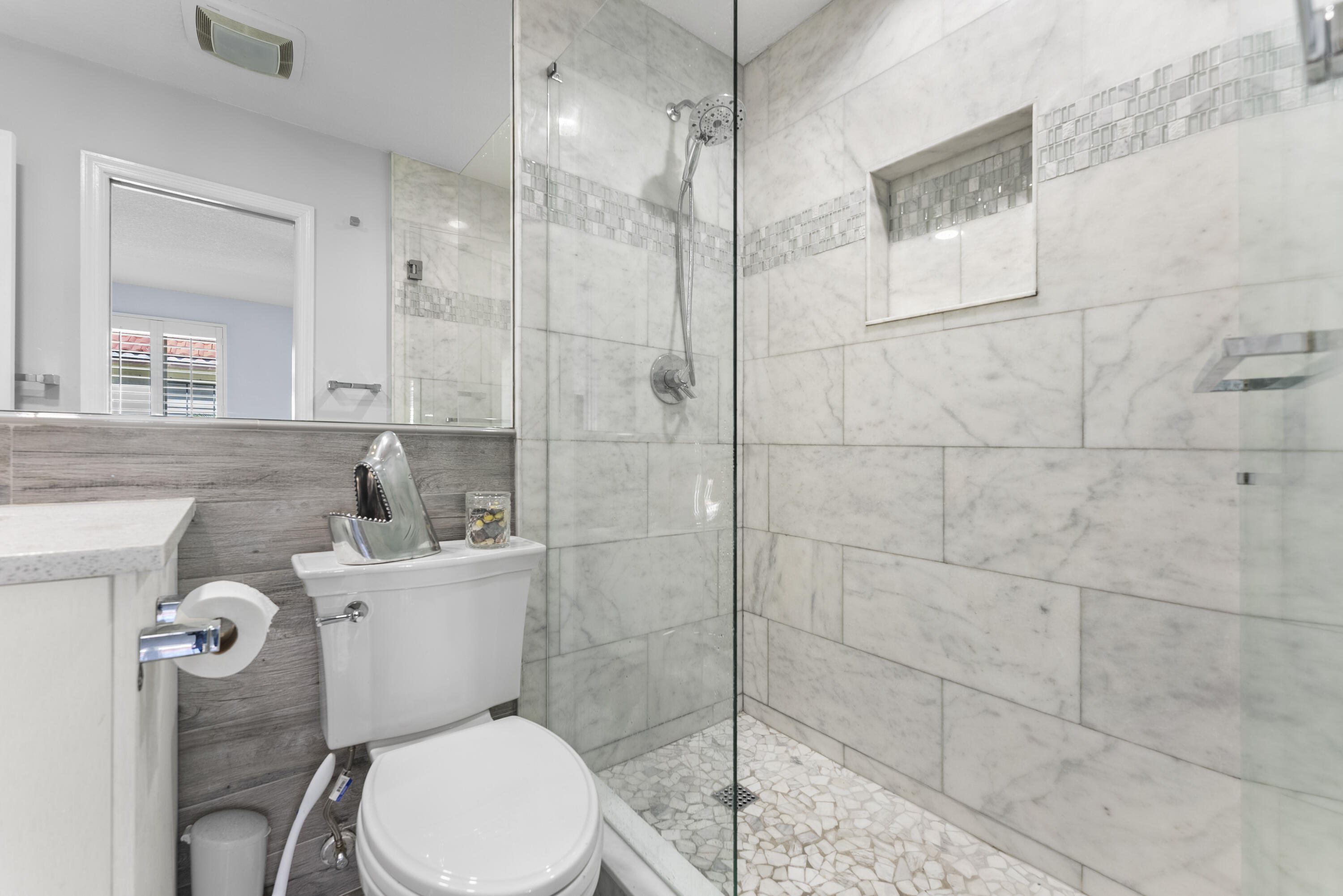 334 Northwest 42nd Street Boca Raton, FL 33431 - Photo 37 of 48 a white toilet sitting next to a bathroom sink