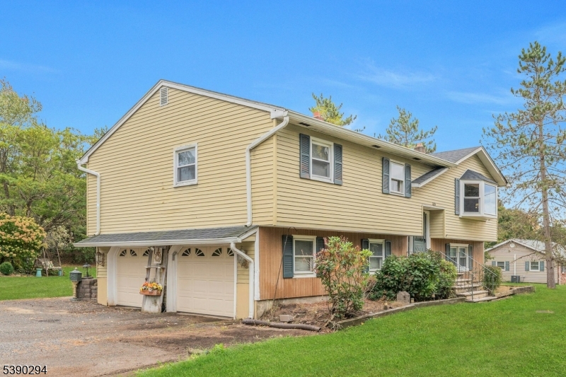 305 Wykertown Road Branchville, NJ 07826 - Photo 1 of 31 a front view of a house with a garden