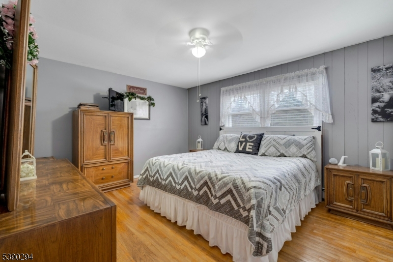 305 Wykertown Road Branchville, NJ 07826 - Photo 15 of 31 a bedroom with a bed and dresser with mirror