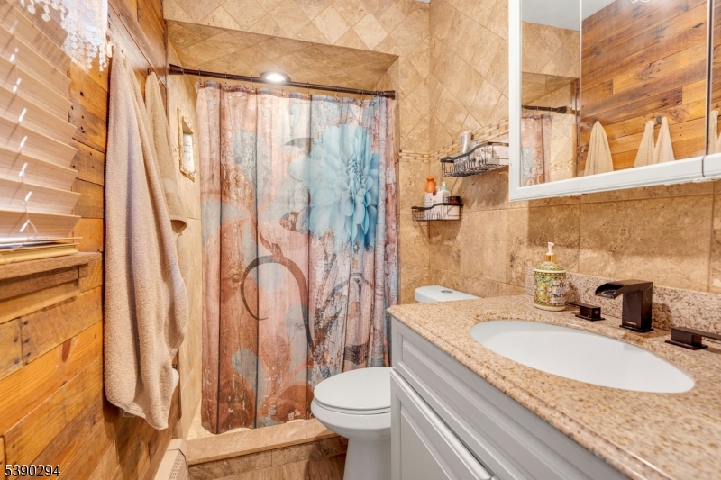 305 Wykertown Road Branchville, NJ 07826 - Photo 17 of 31 a bathroom with a granite countertop sink toilet and shower