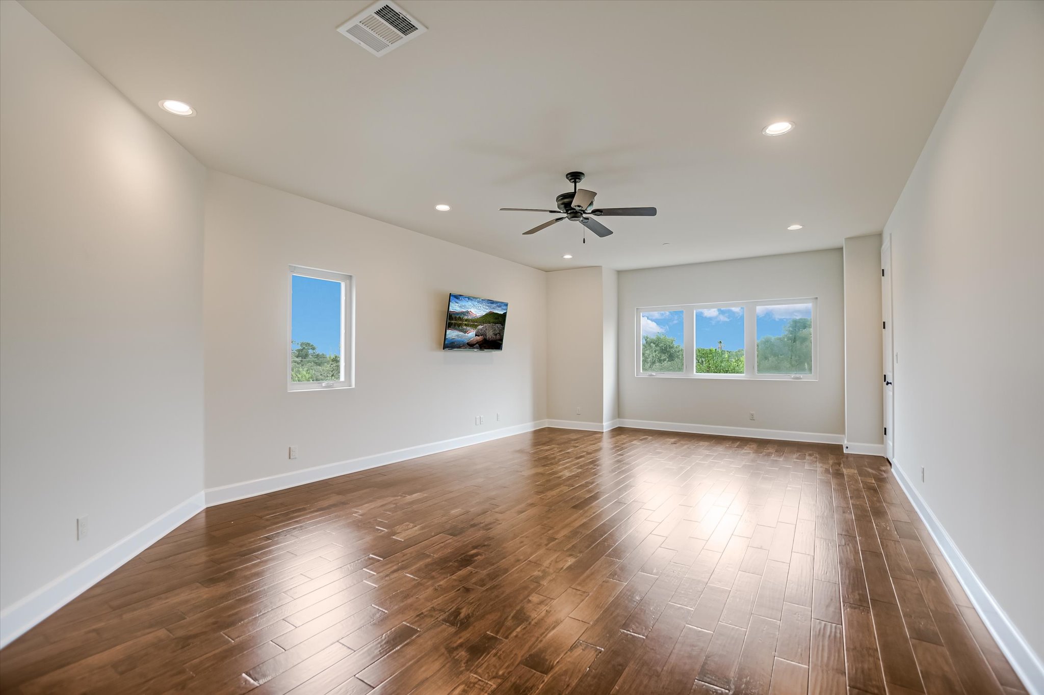 11 Inwood Circle Austin, TX 78746 - Photo 21 of 38 Rich hardwood floors complement high ceilings and ample natural illumination in this inviting open space.