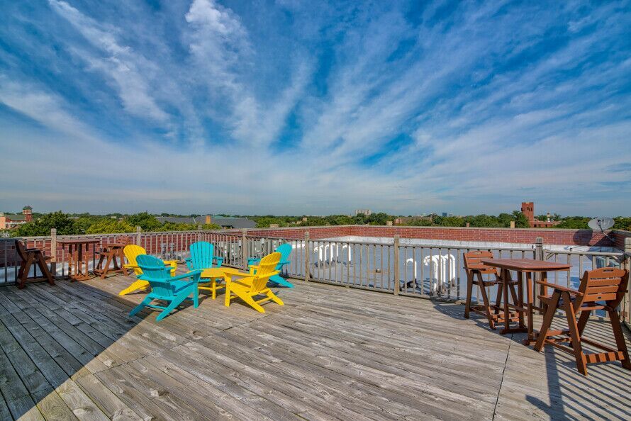 1412 West Morse Avenue, Unit 4B Chicago, IL 60626 - Photo 14 of 16 a view of a balcony with wooden chairs and city view