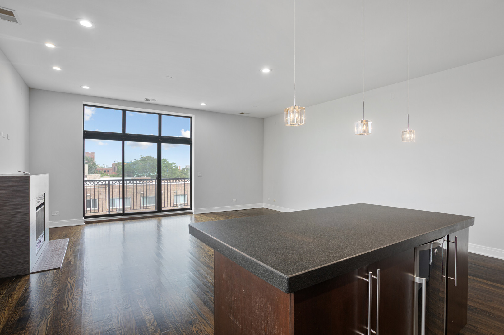 1412 West Morse Avenue, Unit 4B Chicago, IL 60626 - Photo 4 of 16 a view of an empty room with wooden floor and a window