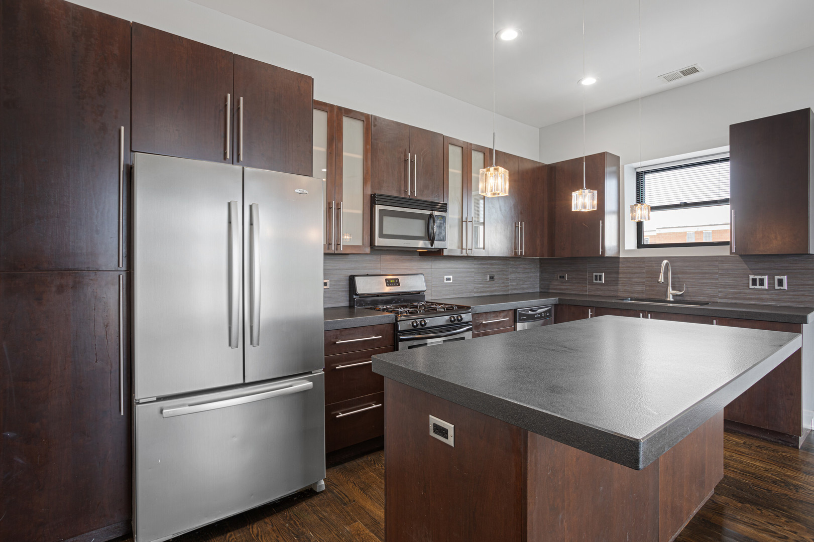 1412 West Morse Avenue, Unit 4B Chicago, IL 60626 - Photo 5 of 16 a kitchen with a refrigerator a sink cabinets and wooden floor