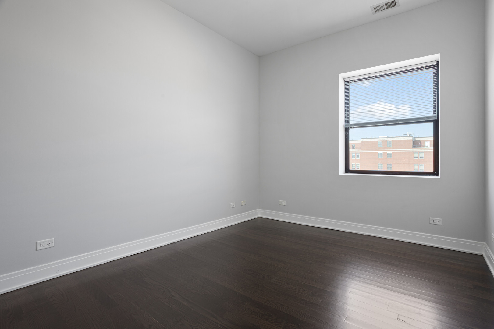 1412 West Morse Avenue, Unit 4B Chicago, IL 60626 - Photo 8 of 16 a view of an empty room with wooden floor and a window