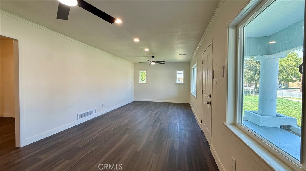 4542 Bandini Avenue Riverside, CA 92506 - Photo 5 of 22 an empty room with wooden floor and windows