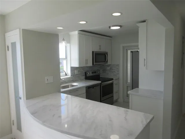 a dining room with furniture a chandelier and wooden floor