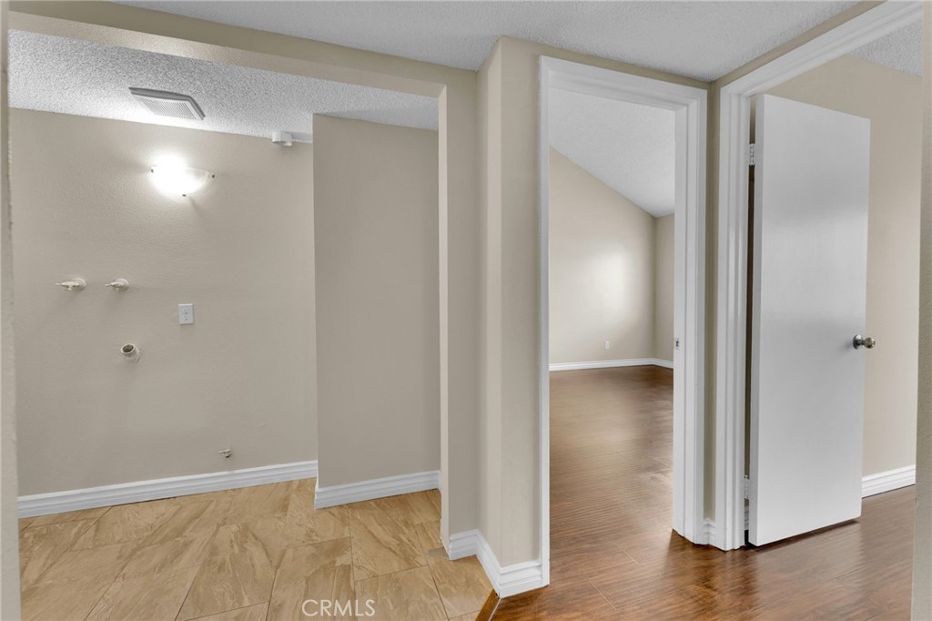 9404 Roundup Drive, Unit B Montclair, CA 91763 - Photo 12 of 37 a view of an empty room with wooden floor