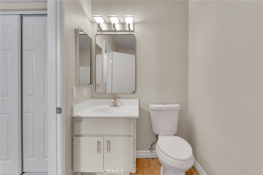 9404 Roundup Drive, Unit B Montclair, CA 91763 - Photo 14 of 37 a bathroom with a toilet sink and mirror