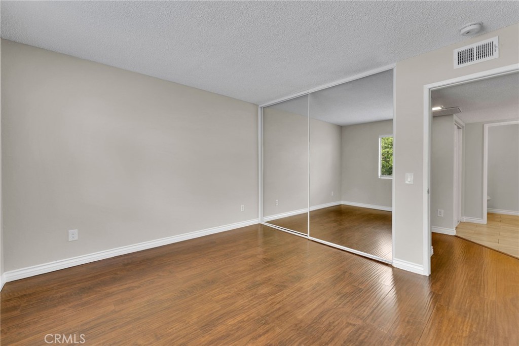 9404 Roundup Drive, Unit B Montclair, CA 91763 - Photo 18 of 37 a view of empty room with wooden floor