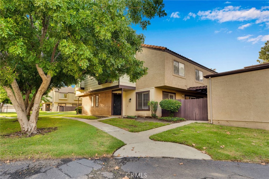 9404 Roundup Drive, Unit B Montclair, CA 91763 - Photo 2 of 37 a front view of a house with a garden and yard