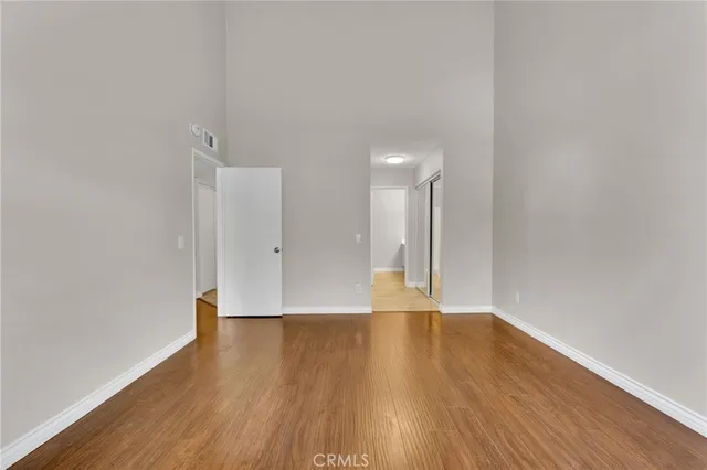 a view of an empty room with wooden floor