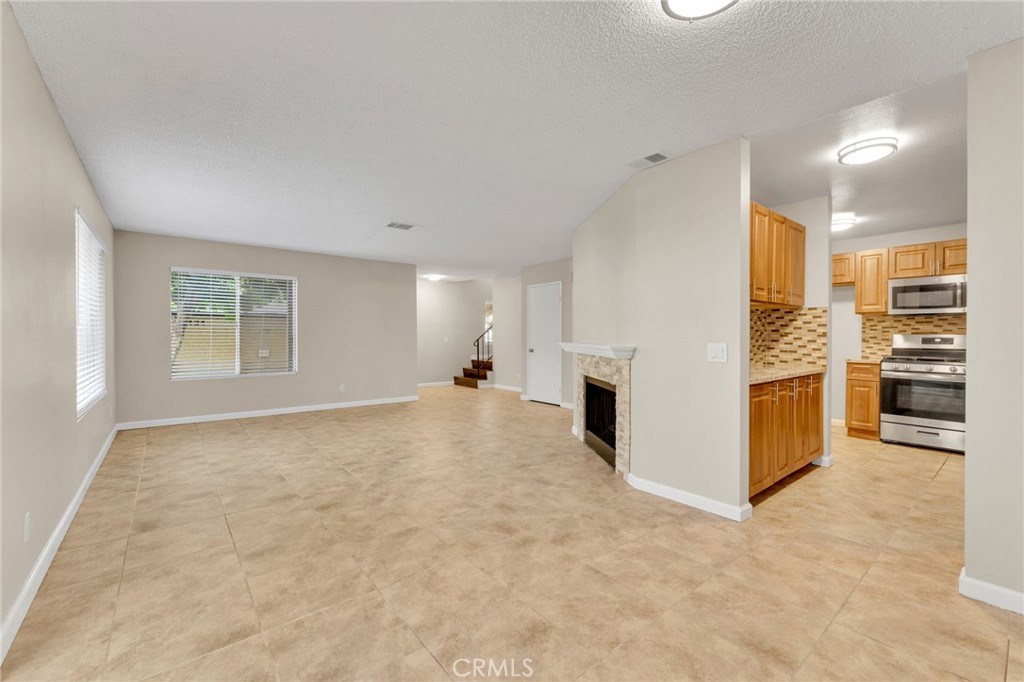 9404 Roundup Drive, Unit B Montclair, CA 91763 - Photo 4 of 37 a view of a kitchen with furniture and an empty room