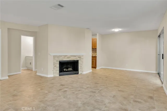 a view of an empty room with a fireplace
