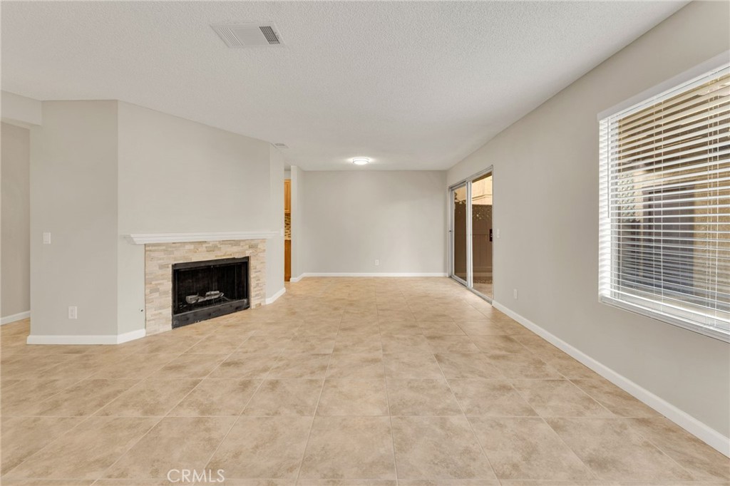 9404 Roundup Drive, Unit B Montclair, CA 91763 - Photo 6 of 37 a view of an empty room with a window and fireplace
