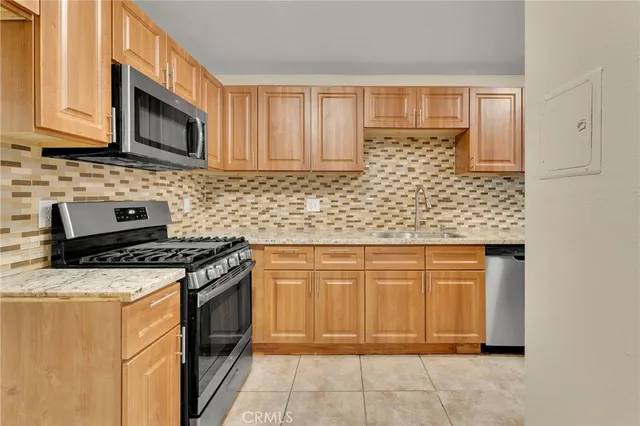 a stove top oven sitting inside of a kitchen