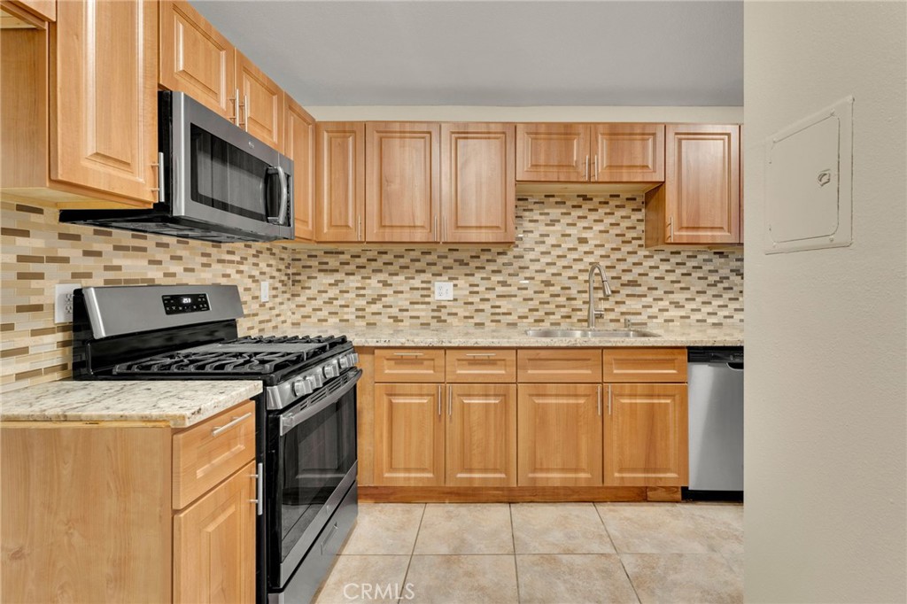 9404 Roundup Drive, Unit B Montclair, CA 91763 - Photo 7 of 37 a stove top oven sitting inside of a kitchen