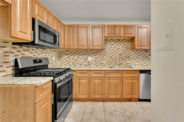 a stove top oven sitting inside of a kitchen