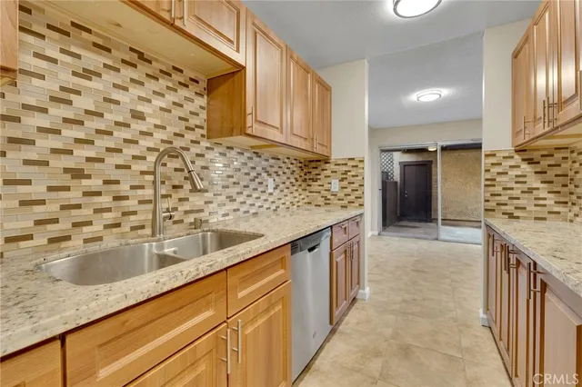 a kitchen with granite countertop a sink and cabinets