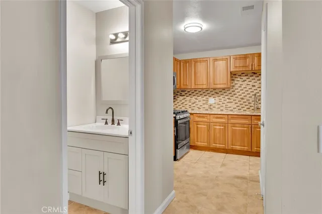 a bathroom with a granite countertop sink a toilet and a mirror