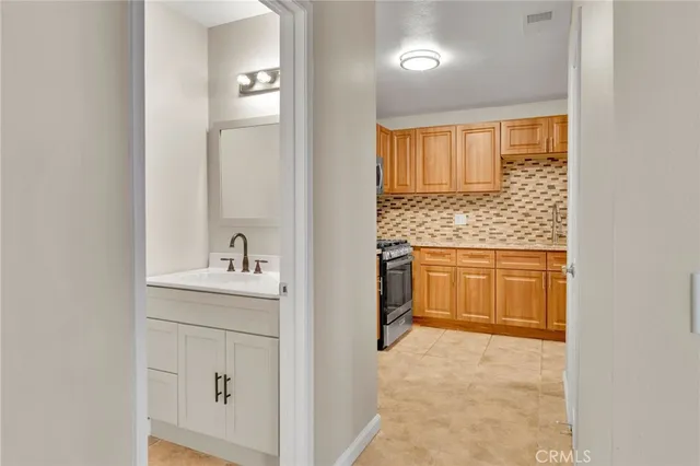 a bathroom with a granite countertop sink a toilet and a mirror