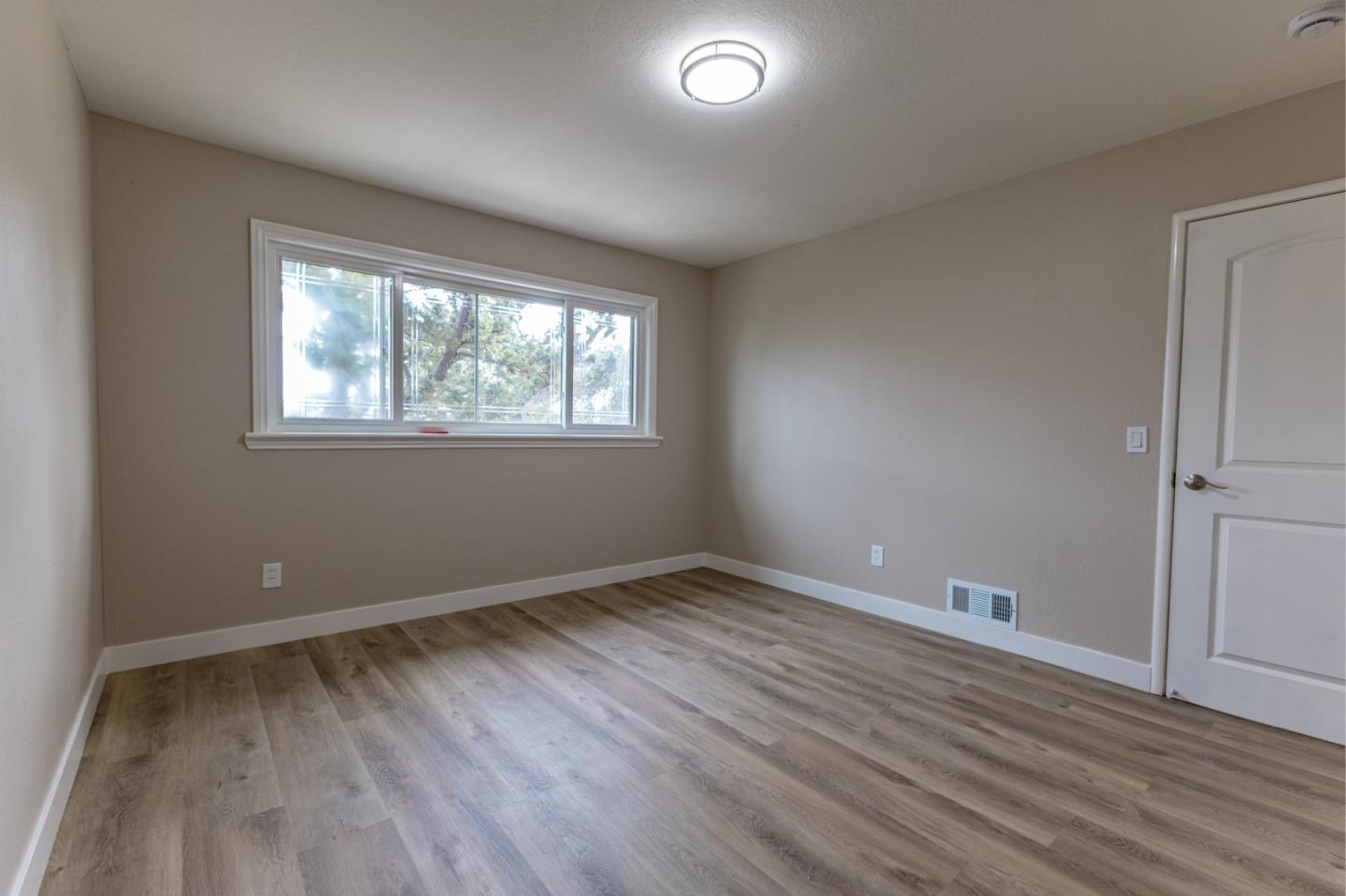 4030 St Marys Street Martinez, CA 94553 - Photo 22 of 28 an empty room with wooden floor and windows