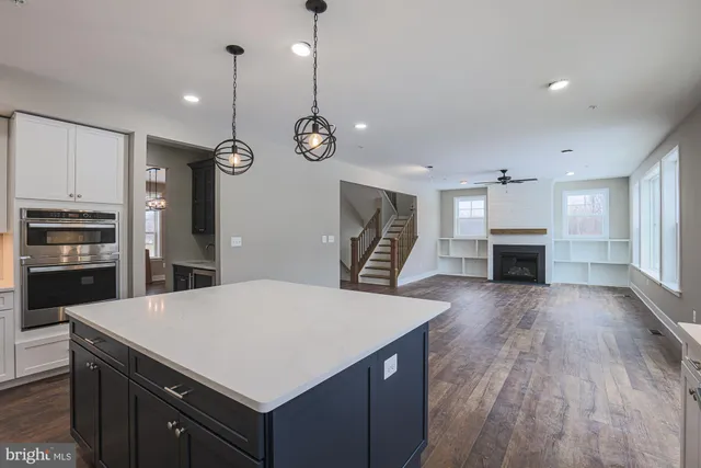 a view of a kitchen with wooden floor and windows