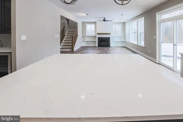 a large kitchen with a lot of counter space and wooden floor