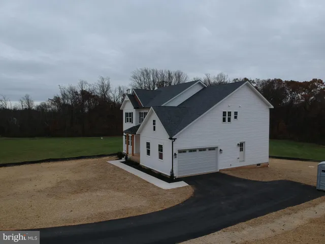 an aerial view of a house with yard