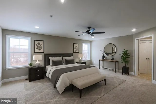 a bedroom with a bed mirror and window