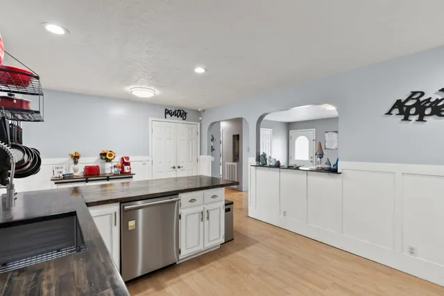 a kitchen with a sink cabinets and wooden floor