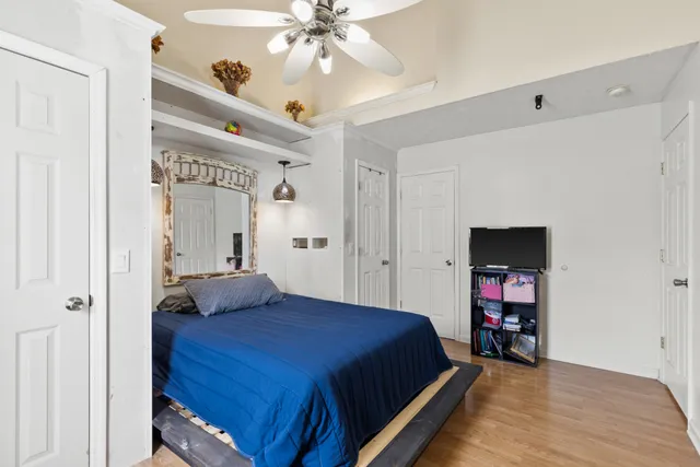 a bedroom with a bed and a chandelier