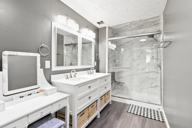 a bathroom with a sink a mirror and a shower