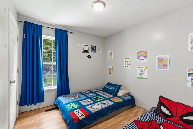 a bedroom with bed and a window