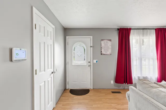 a view of a bedroom with a window and a bed
