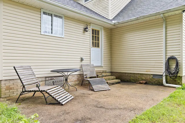 a view of a chairs and table in patio