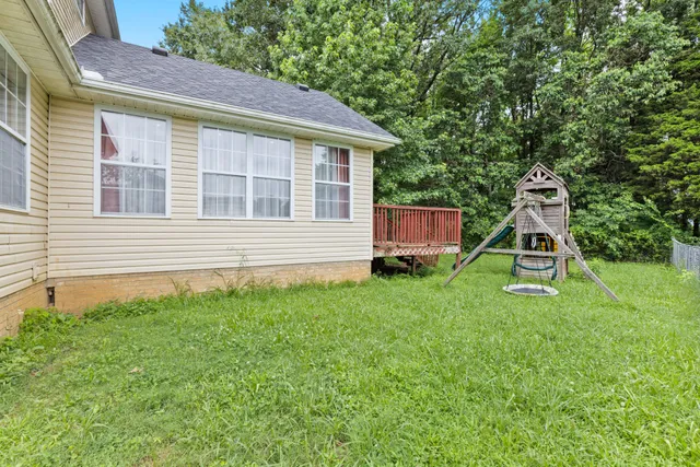 a backyard of a house with table and chairs