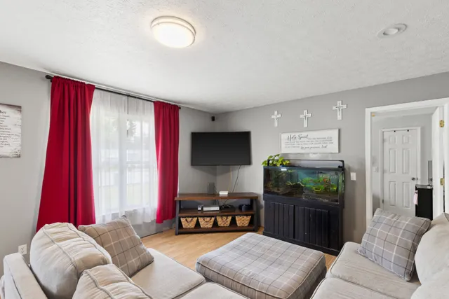 a living room with furniture and a flat screen tv