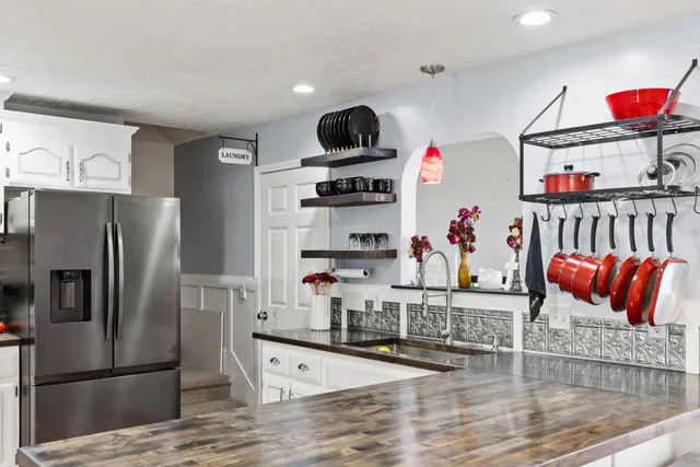 a kitchen with stainless steel appliances granite countertop a refrigerator and a sink