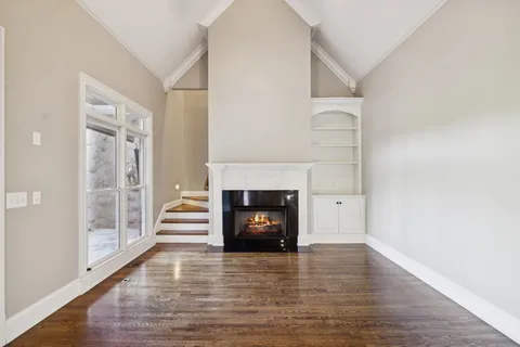a view of a bedroom with wooden floor and cabinet