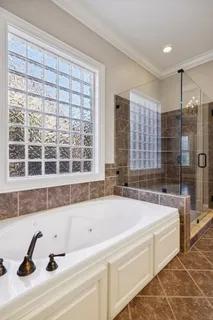 a bathroom with a granite countertop sink a toilet a mirror and shower