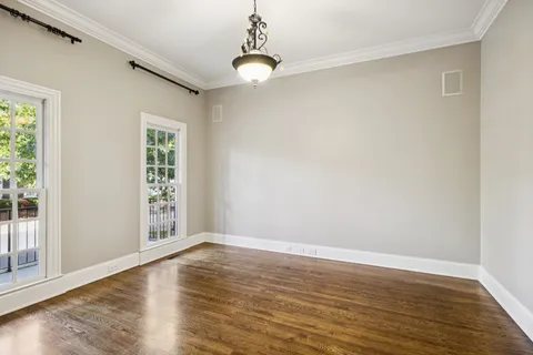 a view of empty room with wooden floor and fireplace