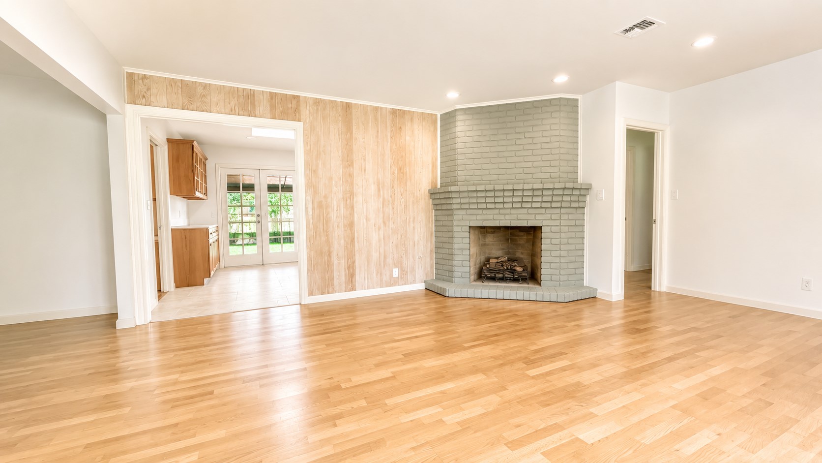 405 Ridgewood Road Austin, TX 78746 - Photo 5 of 22 Spacious interior featuring wood-finish flooring, a painted brick fireplace