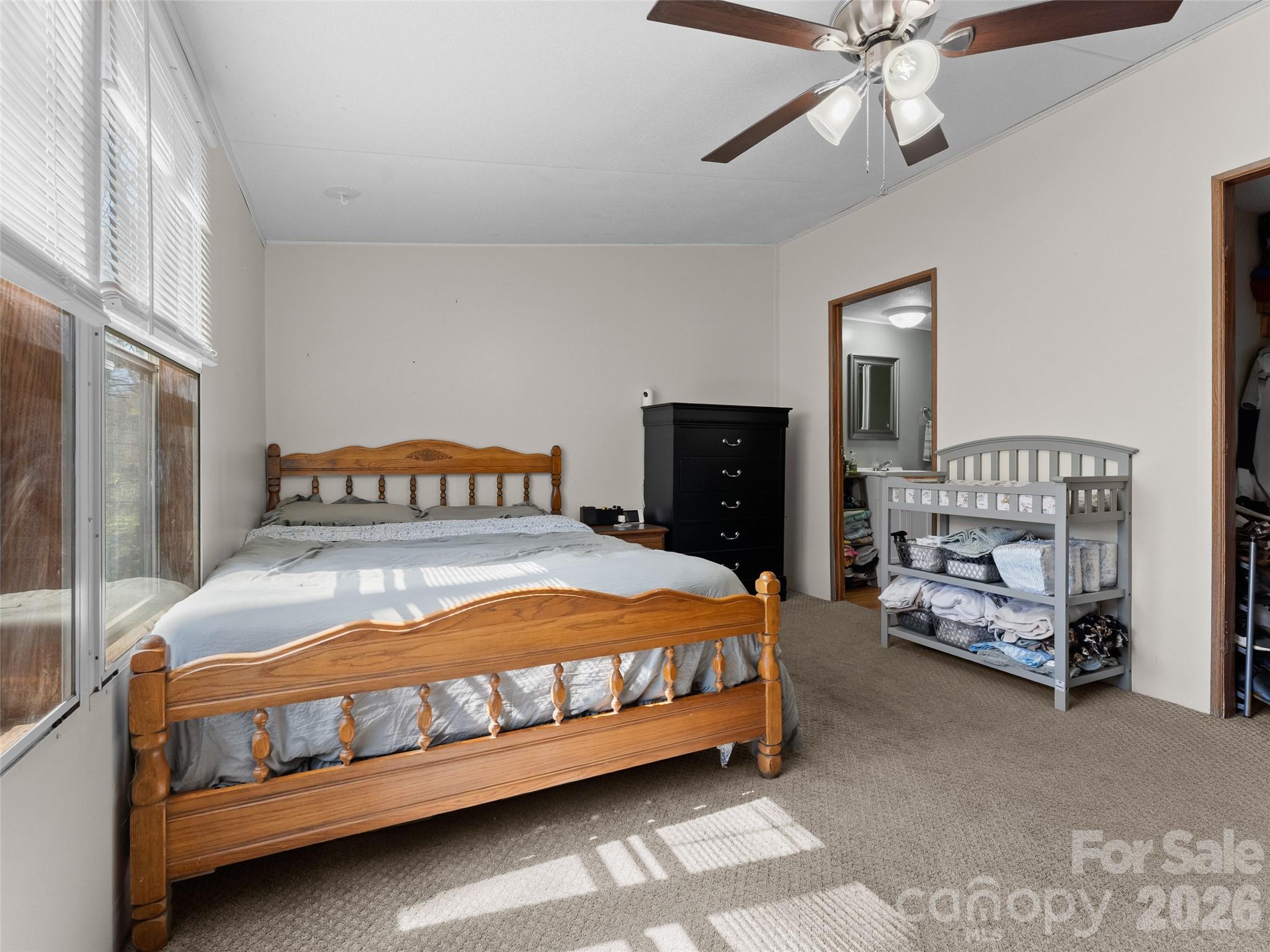 301 Matthew Lane Canton, NC 28716 - Photo 13 of 29 a bedroom with a bed and a chandelier