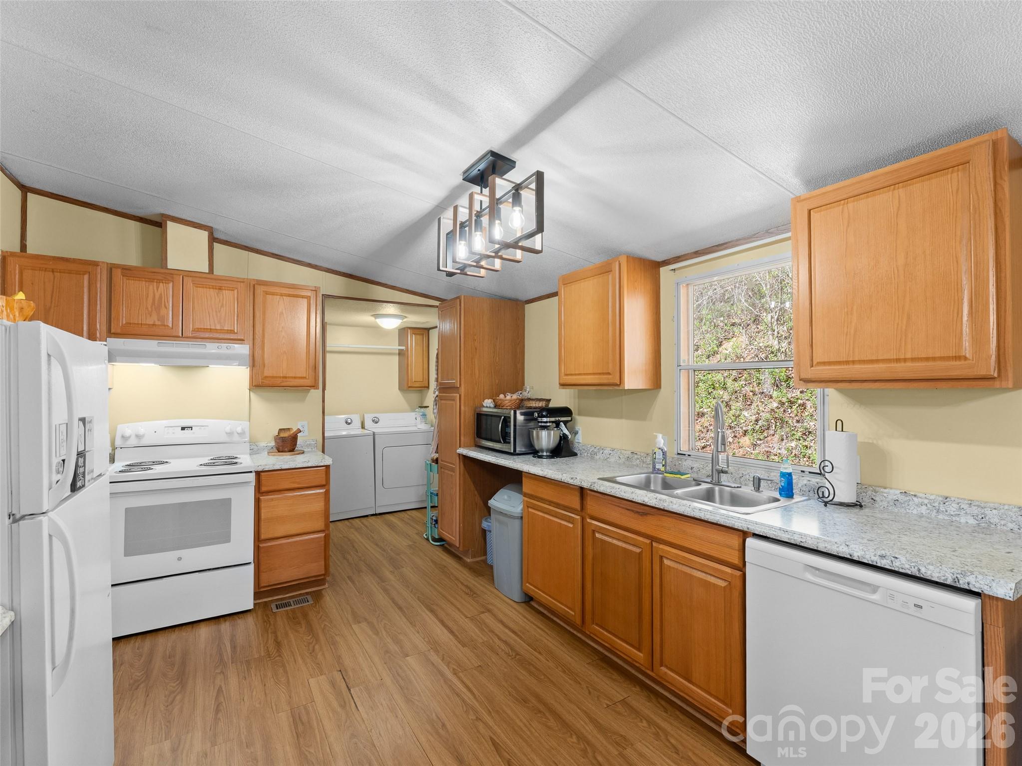 301 Matthew Lane Canton, NC 28716 - Photo 6 of 29 a kitchen with stainless steel appliances granite countertop a sink cabinets and wooden floor