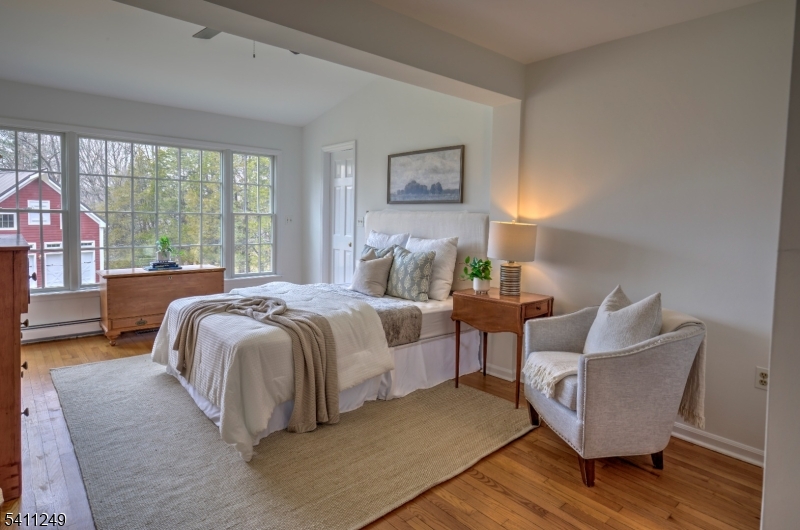 301 Hilltop Road Mendham, NJ 07945 - Photo 18 of 34 a bedroom with a bed and a couch