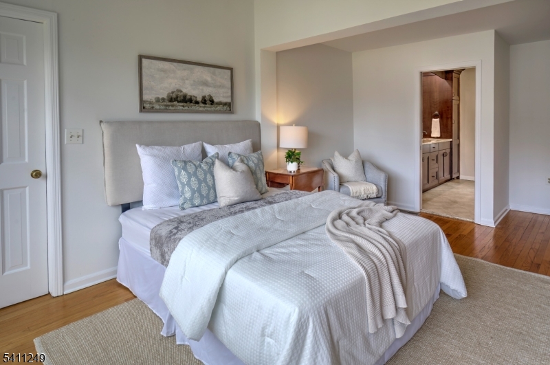 301 Hilltop Road Mendham, NJ 07945 - Photo 19 of 34 a bedroom with bed and painting on the wall