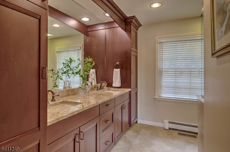 301 Hilltop Road Mendham, NJ 07945 - Photo 20 of 34 a bathroom with a granite countertop sink and a mirror