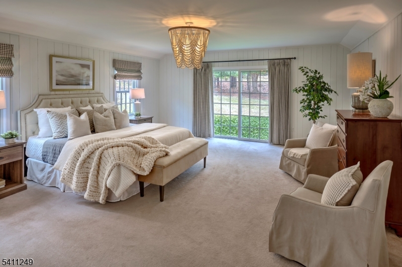 301 Hilltop Road Mendham, NJ 07945 - Photo 22 of 34 a spacious bedroom with a bed and a chandelier